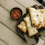 Golden Italian Dunkers with marinara sauce and a sprinkle of parsley.